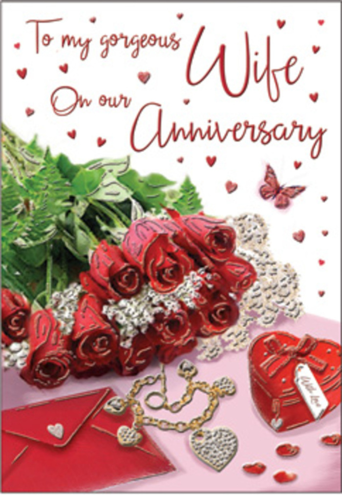 The image presents a rich, romantic tableau that could easily be imagined on a sideboard in a Harlesden home after a surprise anniversary delivery. At the centre is a bouquet of classic red roses, each head perfectly formed, the petals densely layered and gently unfurling as if caught at their most beautiful moment. The blooms are tied together with lush green foliage that spills around them, giving the arrangement a sense of fullness and natural abundance, like a hand-tied bouquet collected from a trusted florist near Harlesden's bustling high street. Around the roses, a collection of keepsakes adds narrative and texture: a vivid red gift box, reminiscent of velvet, hints at jewellery or a treasured memento; beside it rests a coordinating jewellery set, the metal catching the light in warm, subtle flashes. The surface is adorned with delicate heart motifs and possibly lace-like details, creating a tapestry of love symbols that guide the eye from one element to the next. Gentle lighting washes over the scene, accentuating the deep ruby tones of the petals and the soft gleam of gold and silver. You can almost feel the contrast between the smooth, cool jewellery and the plush petals, smell the sweet, heady fragrance of the roses, and sense the weight of years of shared memories. The card's scripted message curves elegantly across the design, embodying the heartfelt words many couples in Harlesden might wish to say, whether they live near Roundwood Park or off Manor Park Road, making this card a meaningful companion to an anniversary bouquet.