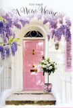 This photograph presents a serene, storybook-like front door in Harlesden, lovingly framed by cascading flowers and a generous bouquet left as a gift. A blush-pink door, simple and inviting, stands against a whitewashed exterior, its colour softened by years of light and weather, reminiscent of the characterful homes around Roundwood Park and the surrounding streets. Overhead, wisteria pours down in soft lavender streams, each trailing cluster of blossom forming a natural canopy that shades the doorway. The petals look thick and velvety, their pastel tones shifting subtly in the sunlight, suggesting a sweet, almost honeyed scent as they sway. At the doorstep, a grey metal bucket has been transformed into an elegant vase, brimming with white and cream roses. The blooms are full and plush, layered with delicate green foliage that spills outward in a relaxed, organic way, as if arranged by a careful local florist with an eye for balance and softness. A pink satin ribbon encircles the bucket and finishes in a small bow, its sheen catching the light and tying the entire scene together with a single, graceful detail. The light itself is gentle and golden, slipping between the wisteria leaves and casting dappled patterns across the stone step and pale door. The mood is hopeful yet calm, like the first quiet afternoon in a new home, when boxes are still unpacked but the sense of possibility is immense. It suggests a Harlesden housewarming moment-a heartfelt floral welcome that turns an ordinary doorway into a symbol of comfort, love, and new beginnings.