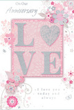 This anniversary card presents a tender celebration of enduring love, its design as soft and comforting as a pastel bouquet delivered to a doorstep in Harlesden. At the heart of the card, the word LOVE is formed from raised, soft glitter, each letter edged in a subtle shimmer that catches the light. The letter O is replaced by a shimmering silver heart, gently textured so it would feel slightly embossed beneath the fingertips, adding both visual focus and emotional warmth. Surrounding this centrepiece, delicate blooms in blush pink and muted mauve unfold with a watercolour softness, their lightly shaded petals giving the impression of fresh flowers just opened that morning in a local NW10 flower studio. Flowing lines of stems and leaves curl around the blossoms, creating a sense of gentle movement, like flowers swaying in a sheltered garden. Tiny flourishes-scattered petals, fine swirls, and discreet butterfly motifs-add lightness and romance, evoking the feel of an English spring garden you might wander through after work. The background holds to a palette of soft pinks and silvery greys, enhancing the feeling of treasured intimacy rather than bright celebration. Elegant script on the front carries the words On Our Anniversary and I love you today and always, written as though with a careful hand. Overall, the card's composition feels like a thoughtfully arranged bouquet translated into illustration: calm, heartfelt, and perfectly suited to honour a shared journey together in Harlesden.